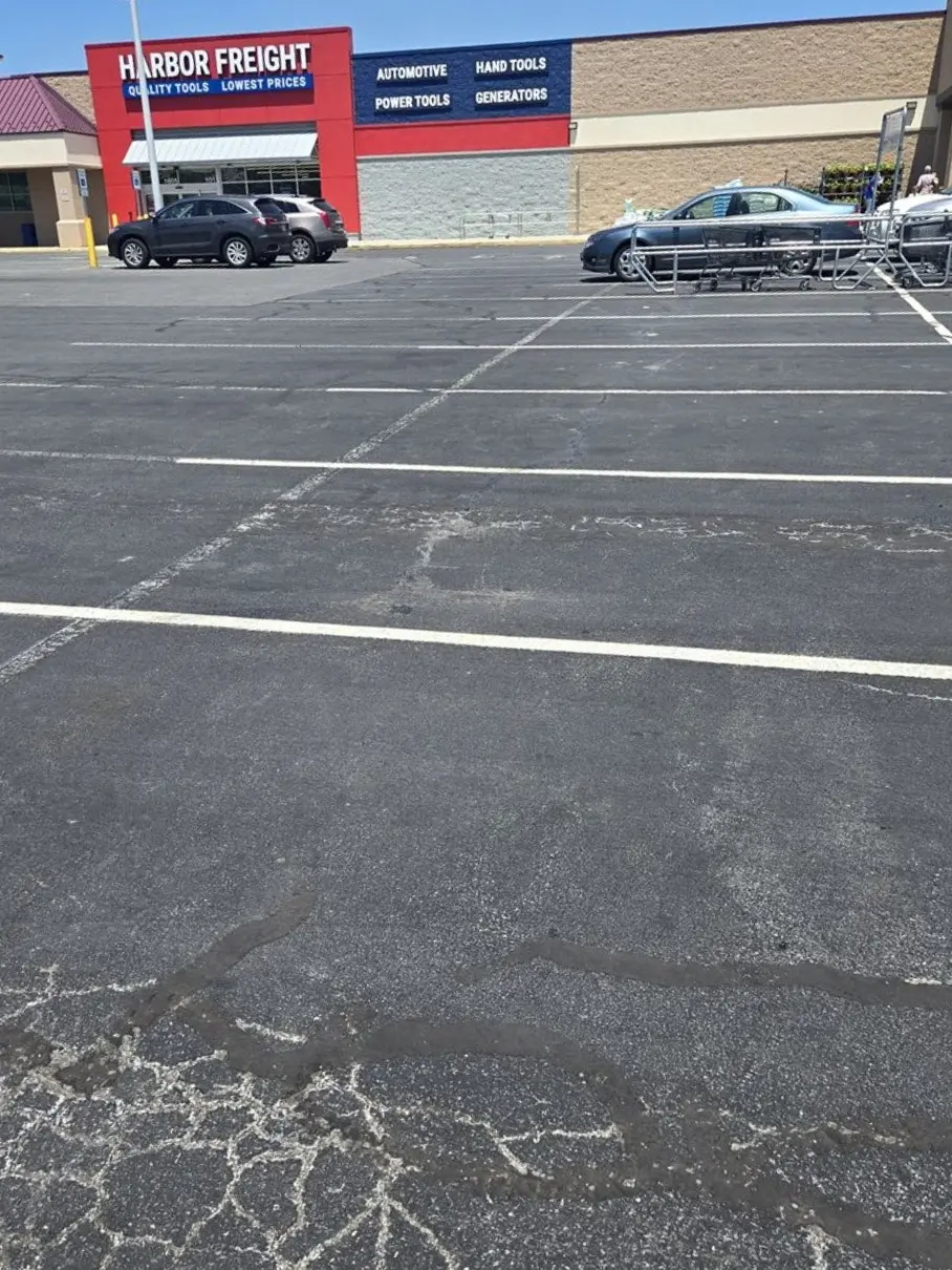 Commercial parking lot at Harbor Freight showing asphalt patching and repair work